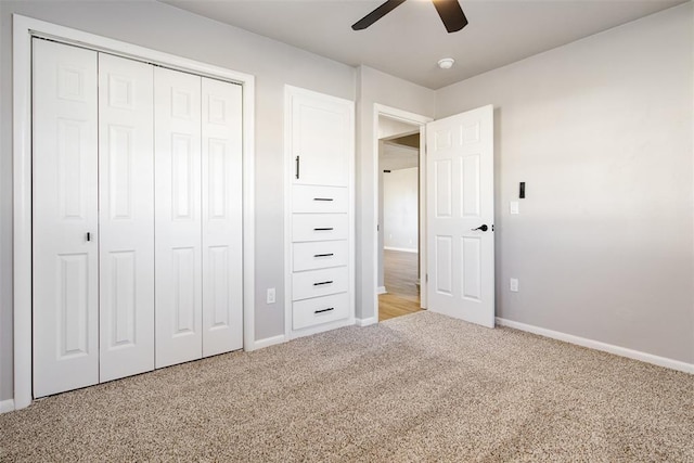 unfurnished bedroom with a ceiling fan, carpet, a closet, and baseboards