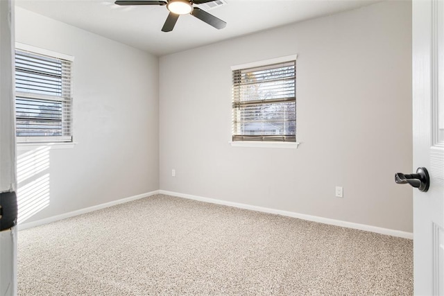 spare room featuring a ceiling fan, baseboards, and carpet floors