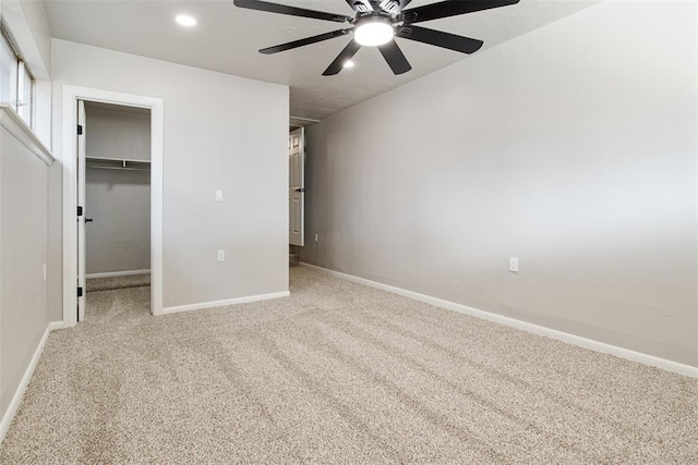 unfurnished bedroom with a spacious closet, baseboards, carpet floors, recessed lighting, and a closet