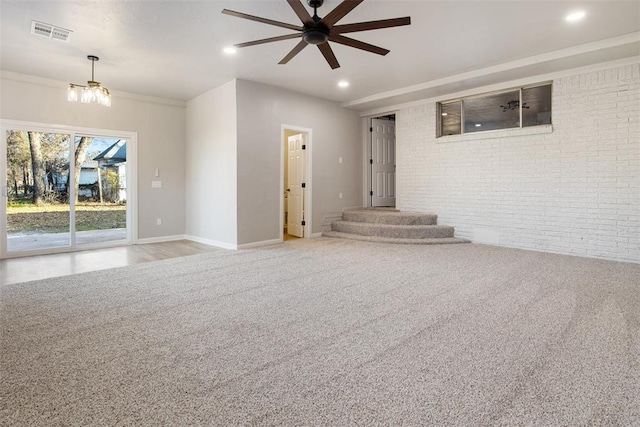 unfurnished room with recessed lighting, visible vents, light carpet, and brick wall