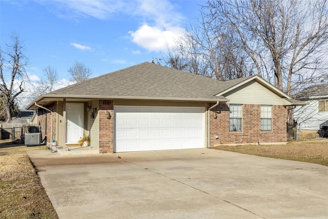 single story home with central AC and a garage