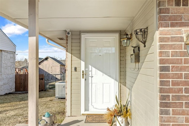 view of exterior entry featuring central AC unit