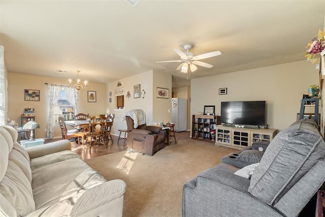 living room with light carpet and ceiling fan with notable chandelier