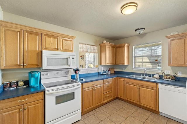 kitchen with light tile patterned floors, sink, and white appliances