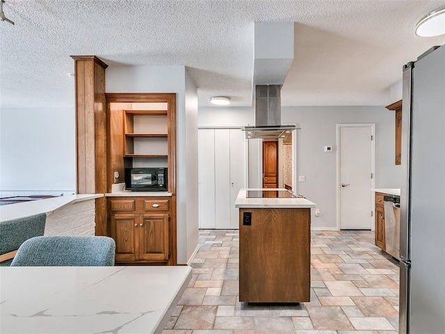 kitchen with island range hood, a center island, black appliances, a barn door, and a textured ceiling