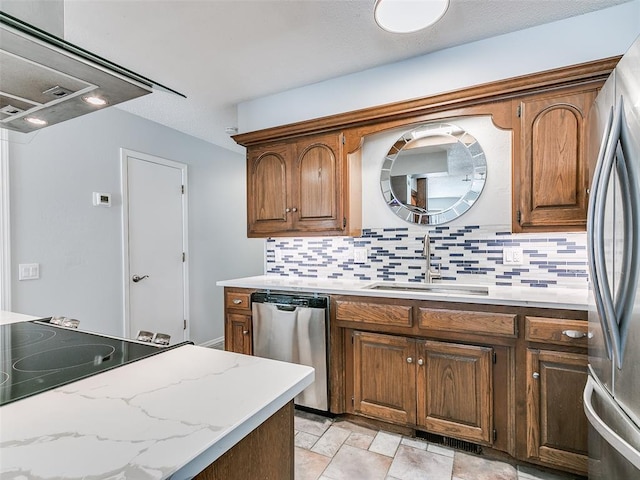 kitchen featuring appliances with stainless steel finishes, sink, and decorative backsplash