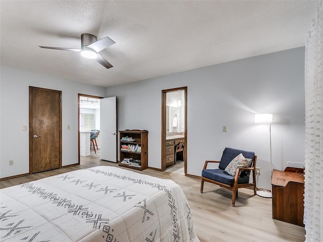 bedroom with a textured ceiling, light hardwood / wood-style floors, ceiling fan, and ensuite bathroom