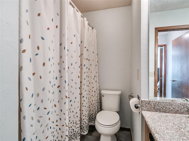 bathroom with vanity, curtained shower, toilet, and a textured ceiling