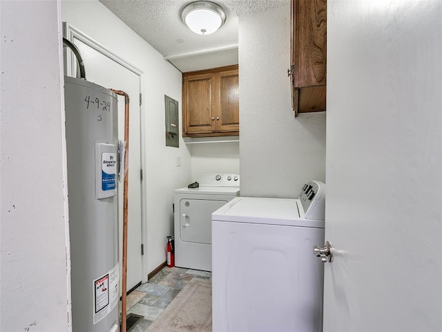 laundry room featuring water heater, electric panel, cabinets, independent washer and dryer, and a textured ceiling