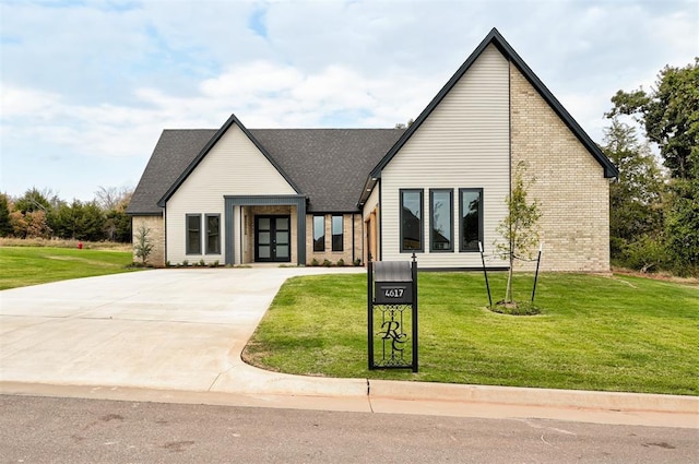 modern farmhouse style home with a front lawn