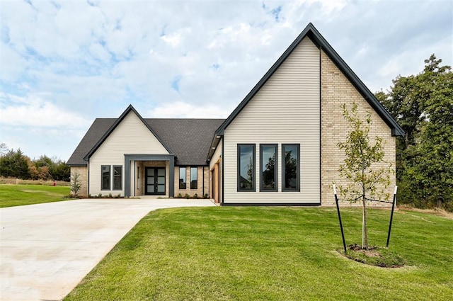 rear view of house featuring a yard