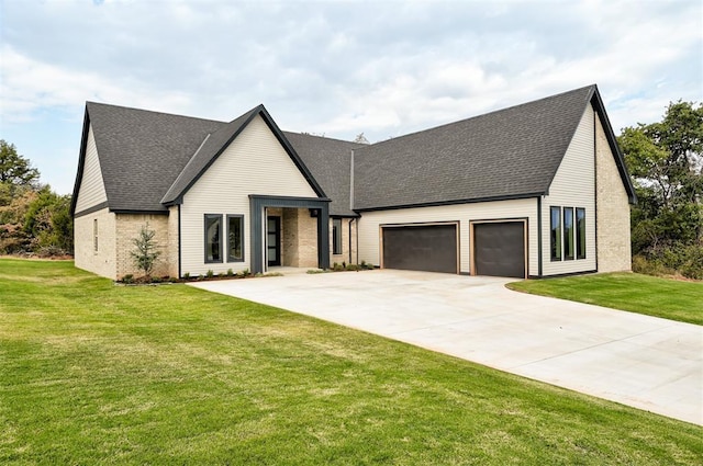 view of front of home with a garage and a front lawn