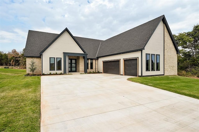 modern inspired farmhouse featuring a garage and a front yard