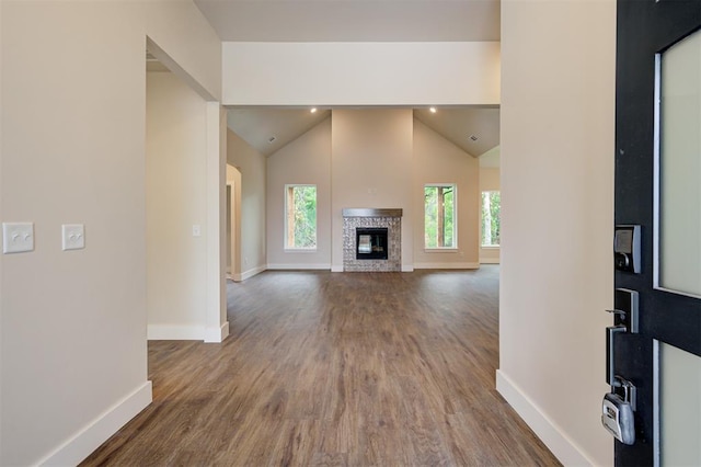 unfurnished living room featuring hardwood / wood-style flooring and vaulted ceiling