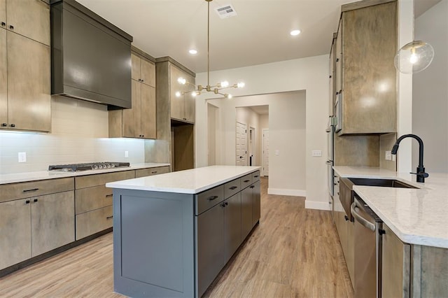kitchen with pendant lighting, appliances with stainless steel finishes, light hardwood / wood-style flooring, and gray cabinetry