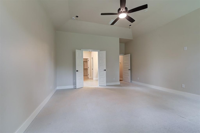 unfurnished bedroom with ceiling fan, high vaulted ceiling, and light carpet