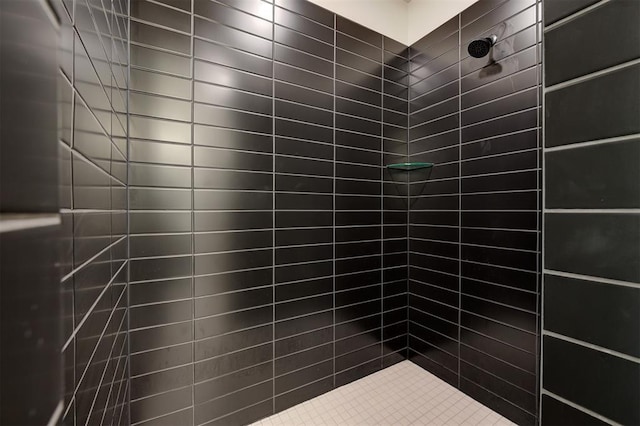 bathroom with a tile shower