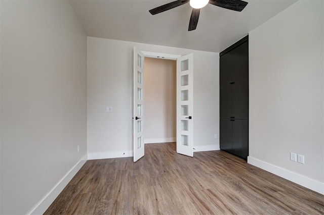 unfurnished bedroom with light hardwood / wood-style floors, a closet, and ceiling fan