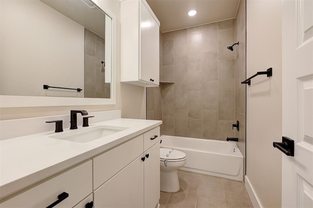 full bathroom featuring tile patterned floors, tiled shower / bath combo, vanity, and toilet