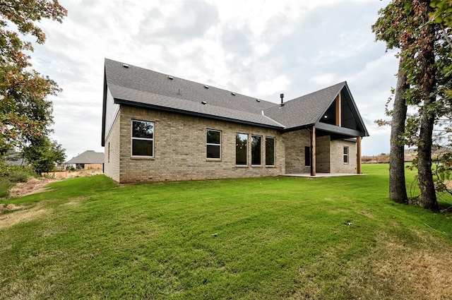 rear view of house with a yard and a patio