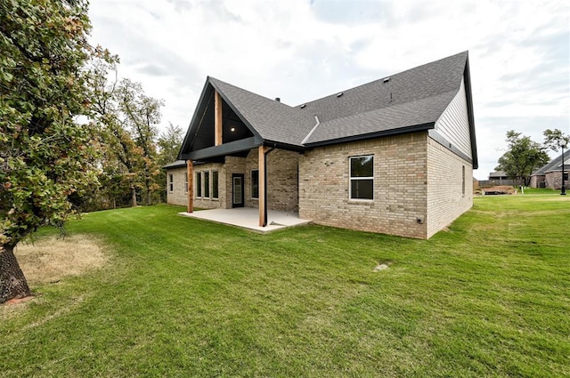 back of property with a patio area and a lawn