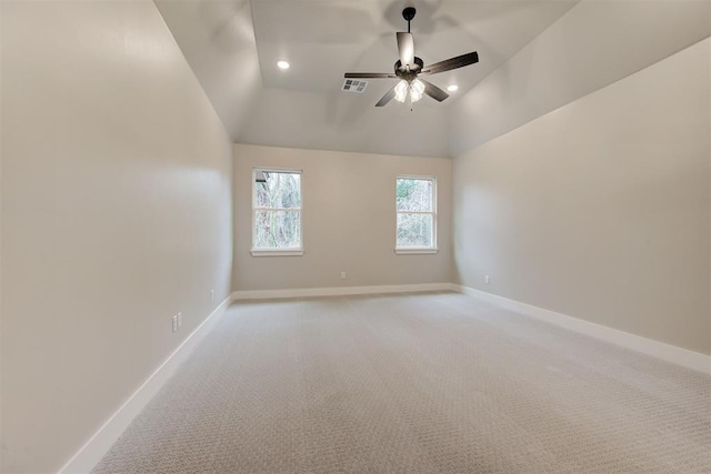 spare room featuring vaulted ceiling, light colored carpet, and ceiling fan