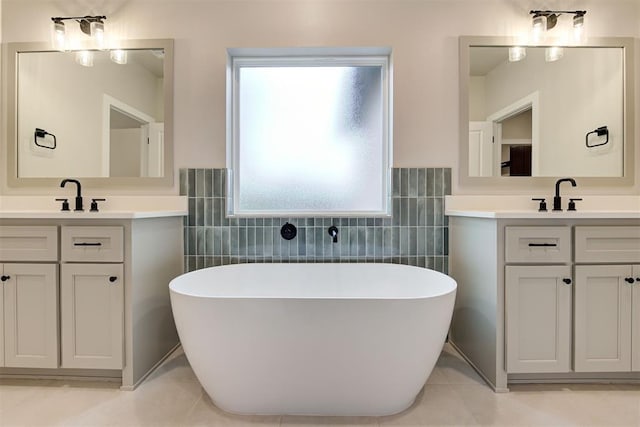 bathroom with a bathing tub, tile walls, tile patterned floors, and vanity