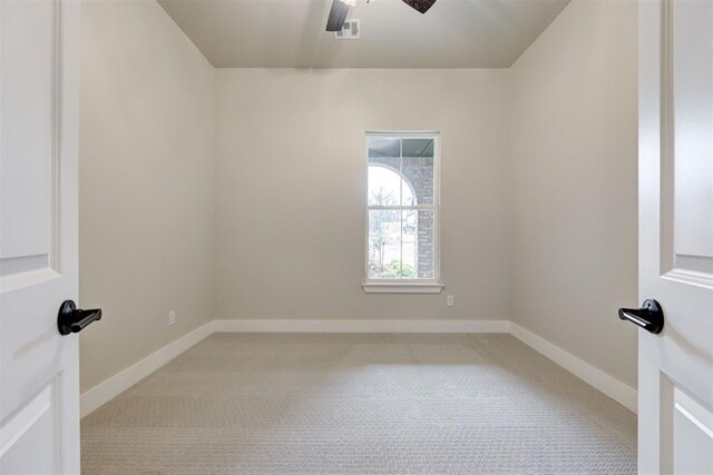 carpeted empty room featuring ceiling fan