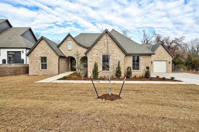 view of front facade with a garage and a front lawn