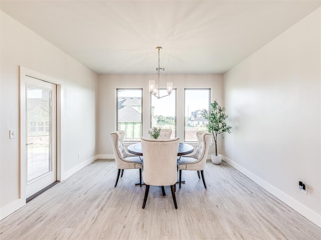 dining room featuring light hardwood / wood-style floors and a chandelier