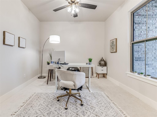 office space with ceiling fan and light carpet