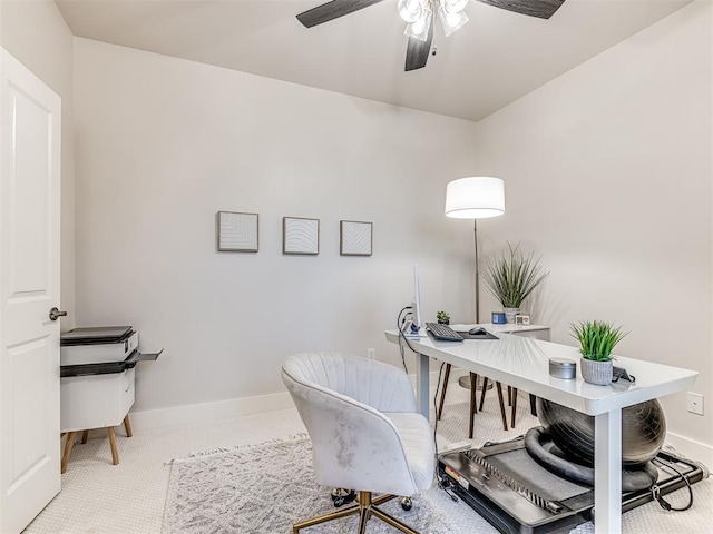 home office with ceiling fan and carpet