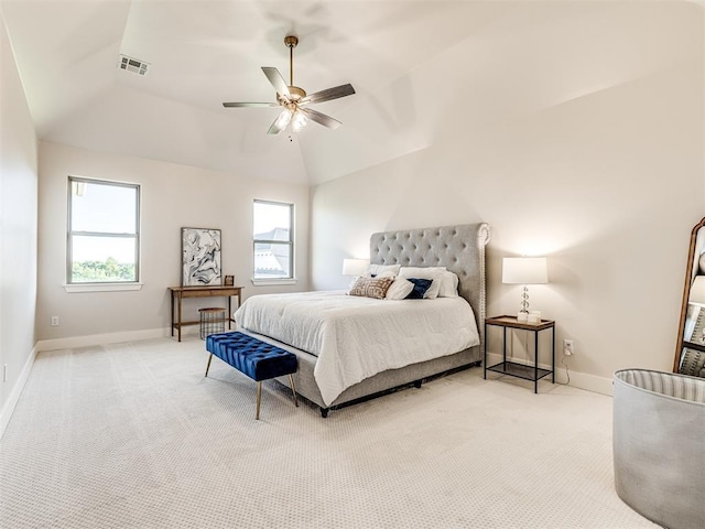 carpeted bedroom with ceiling fan, multiple windows, and lofted ceiling