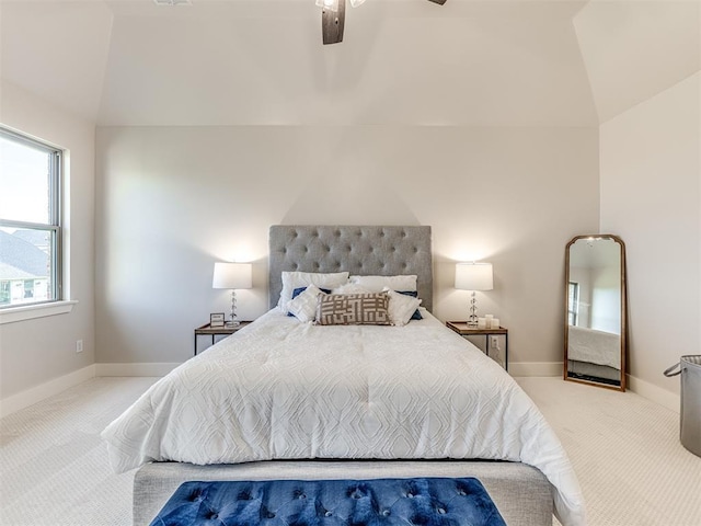 bedroom featuring ceiling fan, light colored carpet, and lofted ceiling