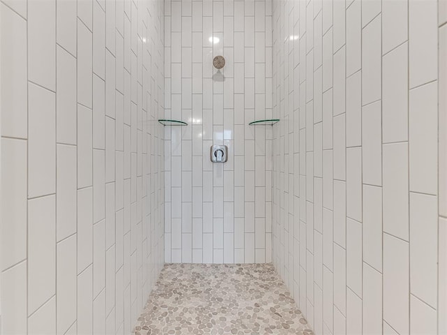 bathroom with a tile shower