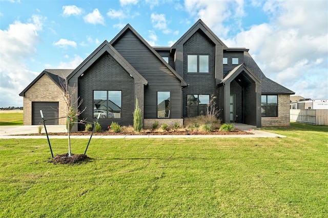 view of front of home featuring a front lawn and a garage