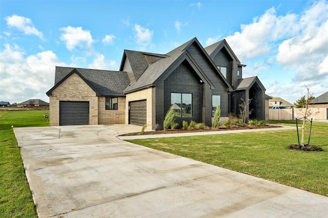 view of front of house with a garage and a front yard