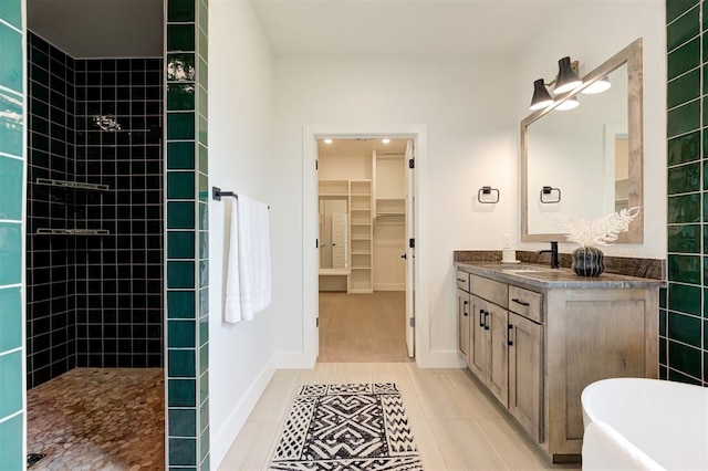 bathroom featuring plus walk in shower, tile patterned floors, and vanity