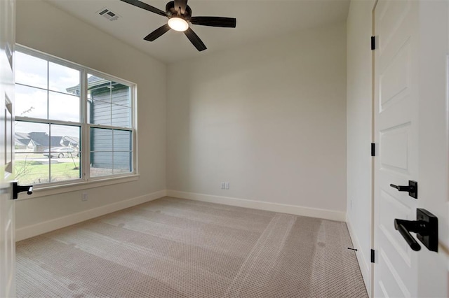 carpeted empty room featuring ceiling fan and a healthy amount of sunlight