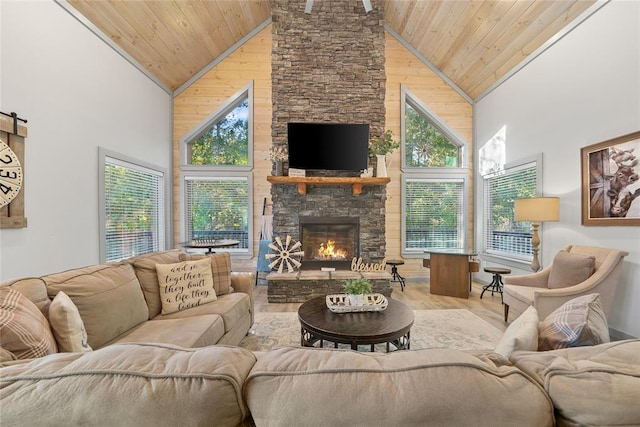 living room with light wood-type flooring, wood ceiling, a fireplace, and high vaulted ceiling