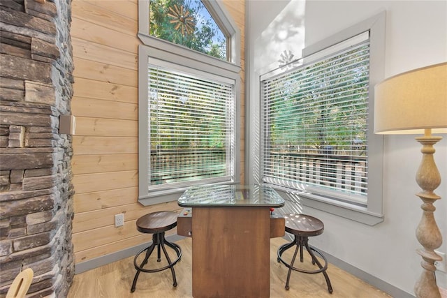 interior space with light hardwood / wood-style floors and wooden walls