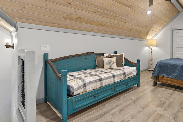 bedroom featuring vaulted ceiling, wood ceiling, and light hardwood / wood-style floors