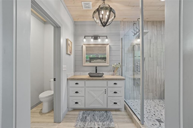 bathroom with wood ceiling, vanity, an inviting chandelier, toilet, and walk in shower