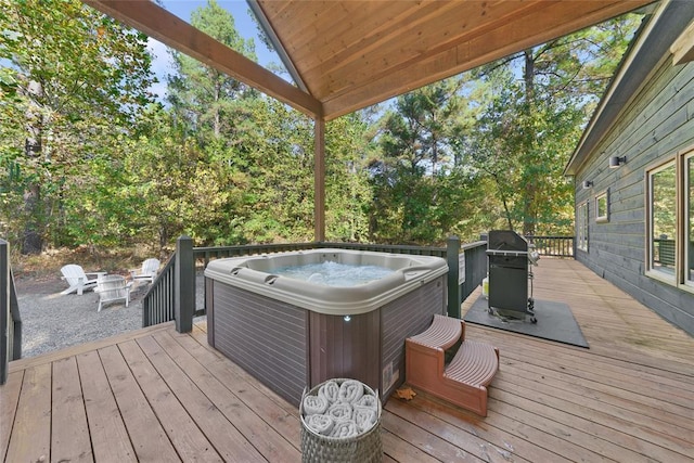 wooden deck featuring a hot tub and grilling area