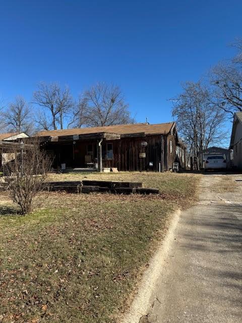 back of property featuring a lawn