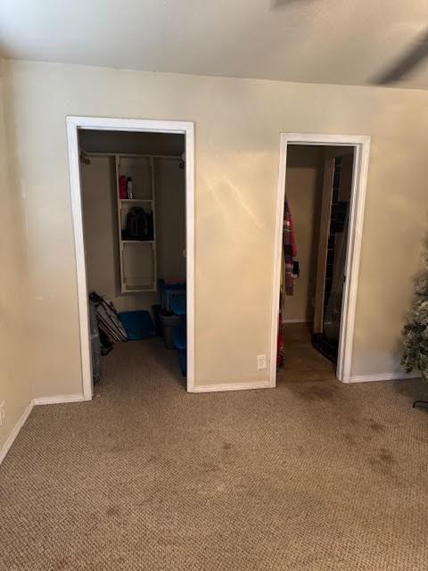 carpeted spare room with baseboards