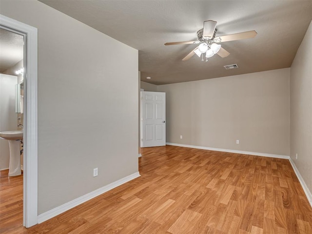 spare room featuring ceiling fan and light wood-type flooring