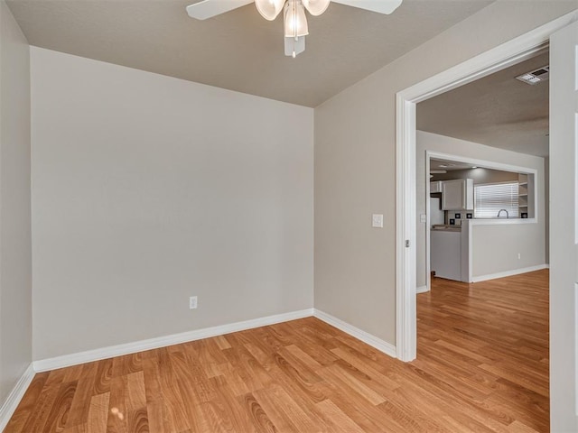 empty room featuring ceiling fan and light wood-type flooring