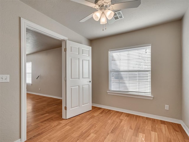 unfurnished bedroom featuring ceiling fan and light hardwood / wood-style flooring