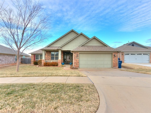 view of front of home with a garage, covered porch, and a front yard